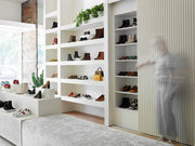 The Toronto store, with shoes on display on white shelves.