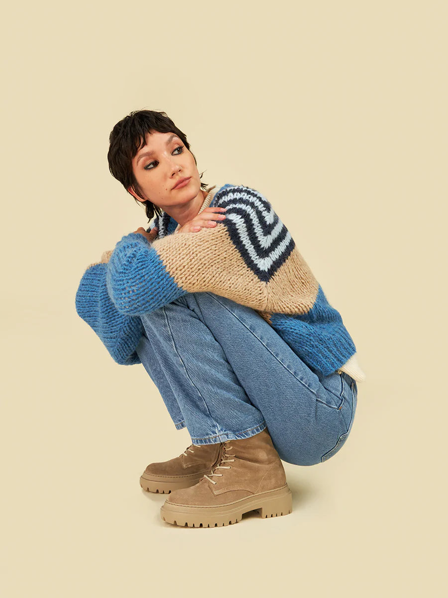 A woman wearing beige suede boots