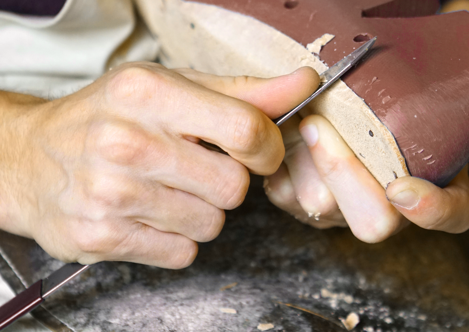 A close view of a shoe made by hand by an artisan.